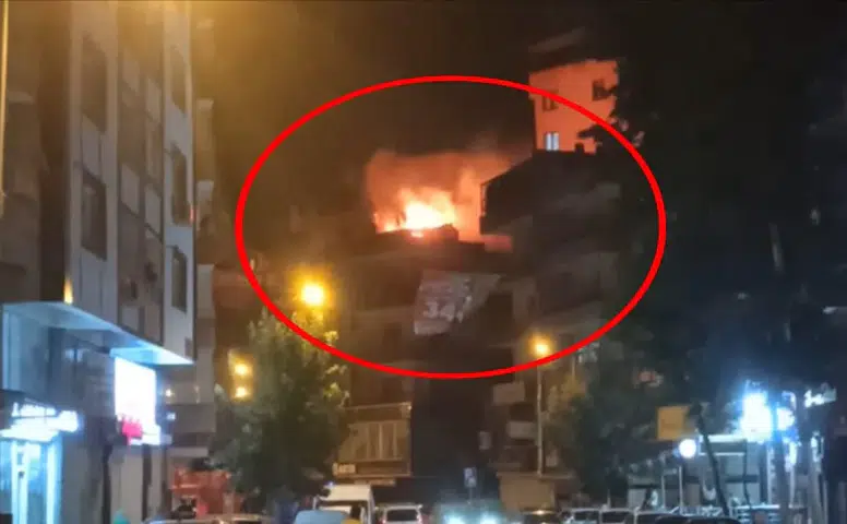 Yenişehir'deki 4 katlı binanın çatısında gece vakti çıkan yangın paniğe yol açtı